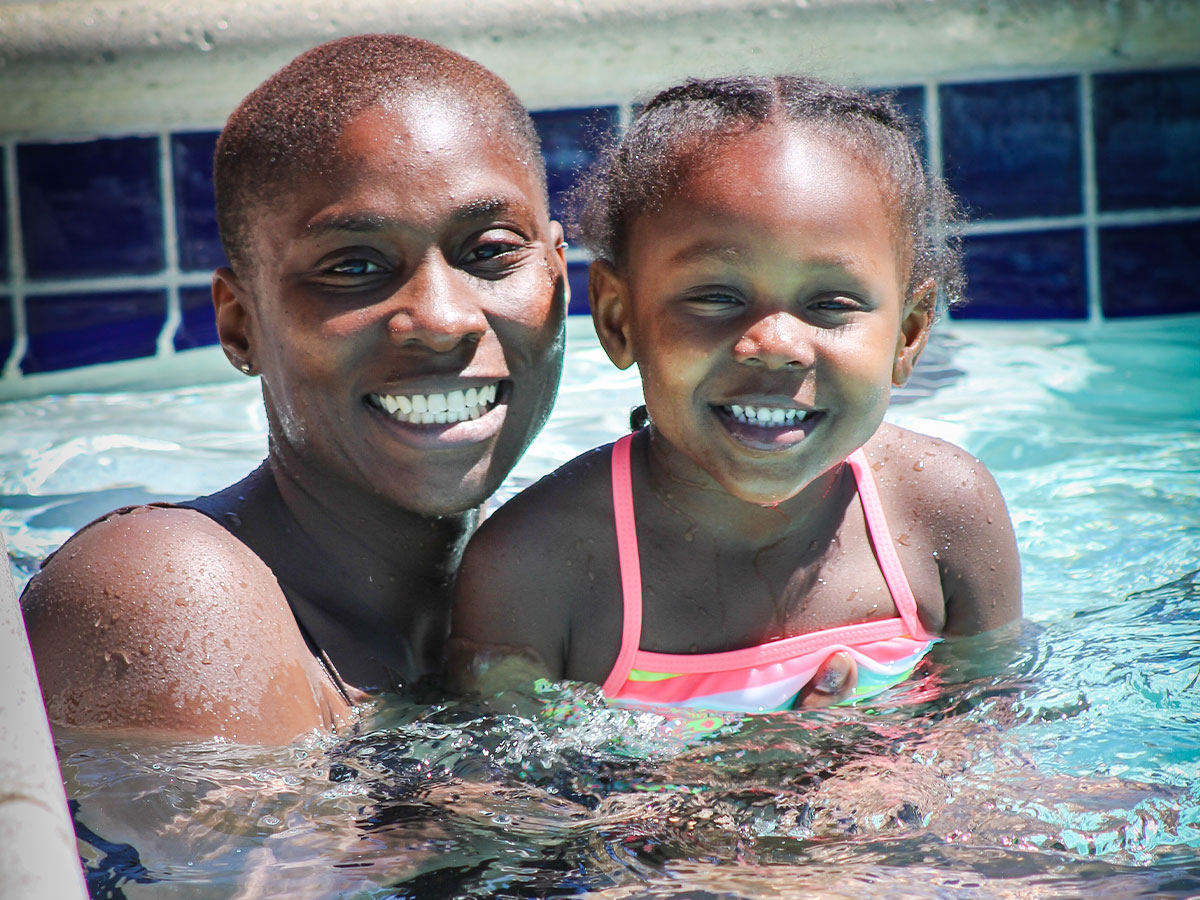 Mom and daughter swimming in the pool at Angeles Crest Christian Camp
